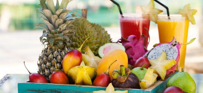 Assortment of tropical exotic fruits with smoothie and fresh juice